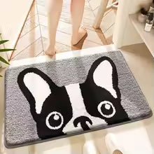 Doormat with a cartoon dog design on a light wooden floor.